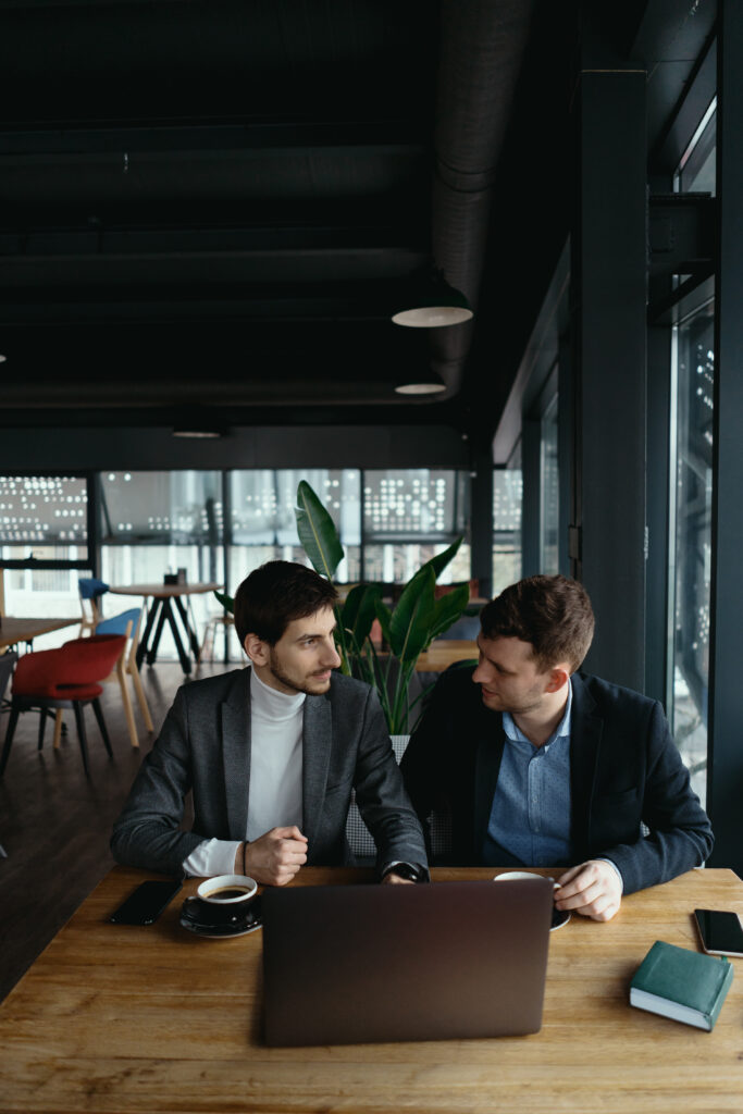 Two young businessman having a successful meeting at restaurant.